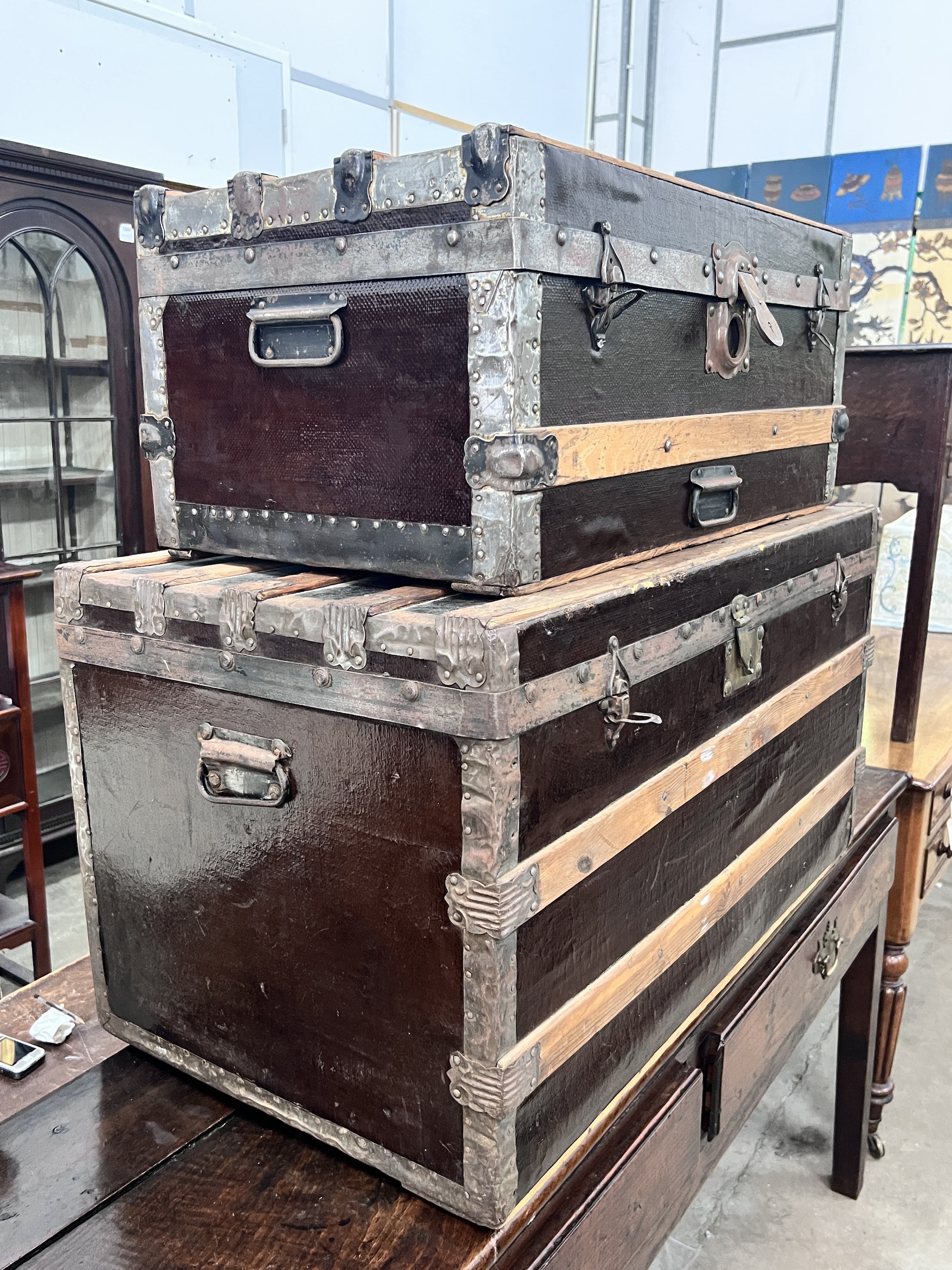 Two wood and metal bound travelling trunks, larger length 86cm, depth 48cm, height 47cm